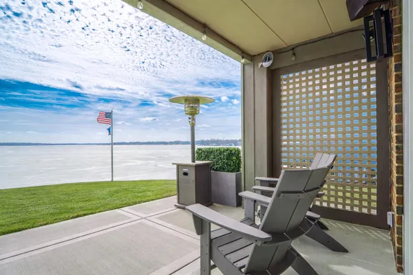 a view of a patio with a table and chairs and potted plants