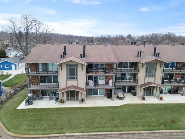 a front view of multiple houses with yard