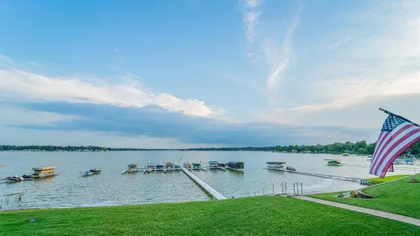 a view of a swimming pool with lawn chairs and couches