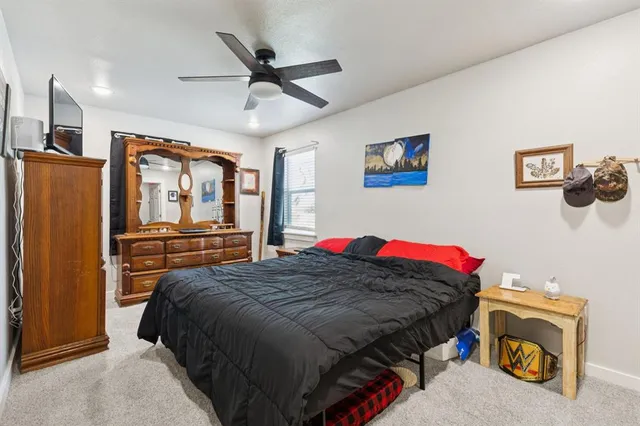 a bedroom with a bed and flat screen tv