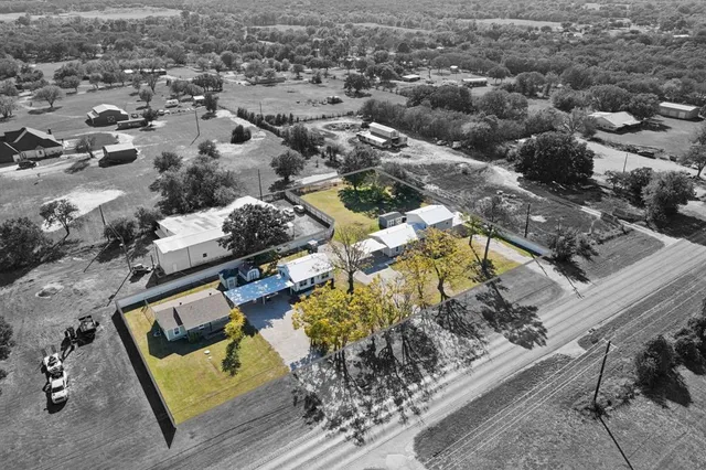 an aerial view of a residential houses with outdoor space