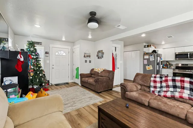 a living room with furniture toys and a window