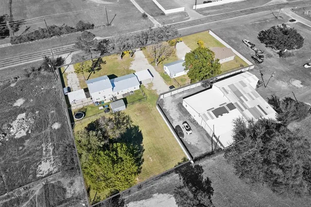 an aerial view of a residential houses with outdoor space