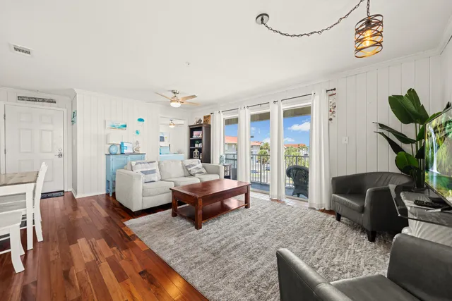 a kitchen with a sink a refrigerator a microwave and cabinets