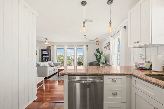 a bedroom with a bed and a lamp on a dresser