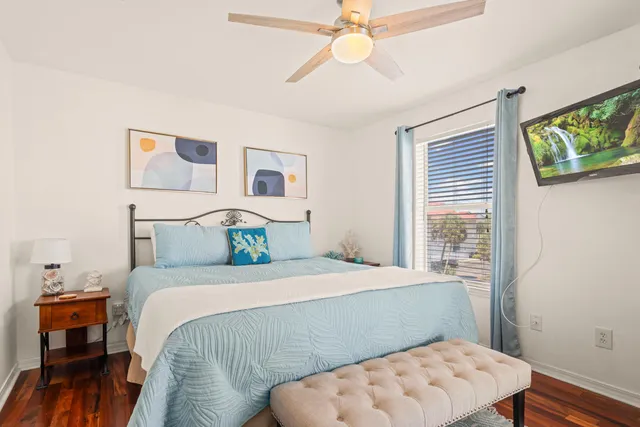a bedroom with a large bed and a chandelier