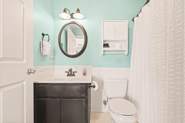 a bathroom with a sink mirror and vanity