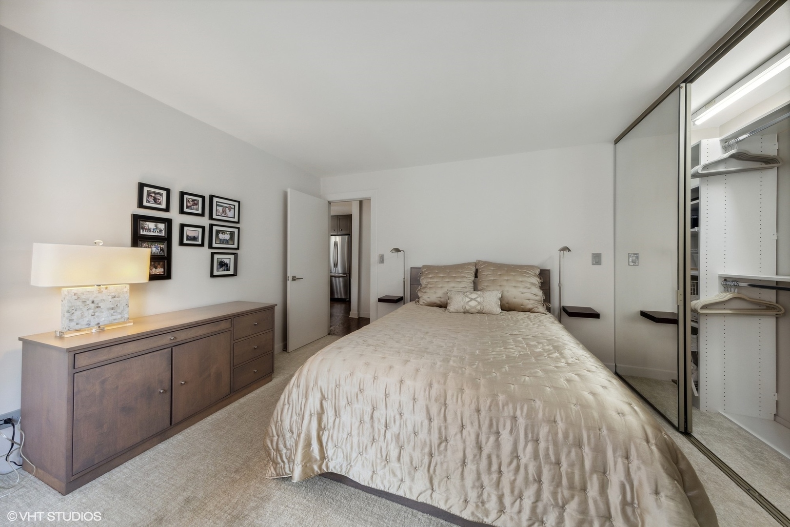 21 West Goethe Street, Unit 8DE Chicago, IL 60610 - Photo 11 of 22 a spacious bedroom with a bed and a dresser