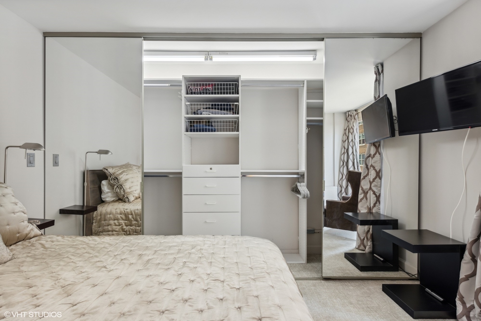 21 West Goethe Street, Unit 8DE Chicago, IL 60610 - Photo 12 of 22 a bedroom with a bed and a flat tv screen