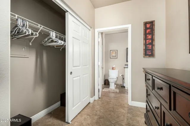 a view of a hallway with closet and wooden floor