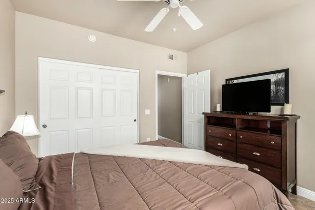 a bedroom with a bed and a flat screen tv