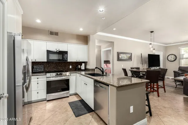 a kitchen with a sink stove and refrigerator