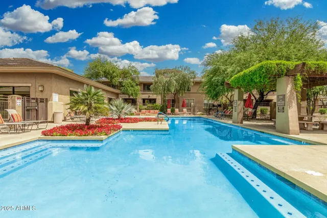 a view of a swimming pool with an outdoor seating
