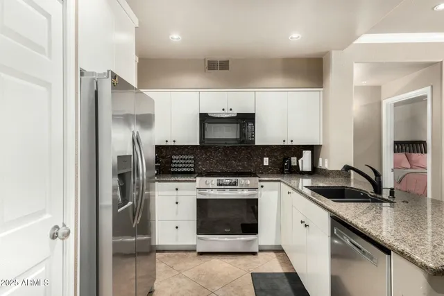 a kitchen with a sink stove and refrigerator