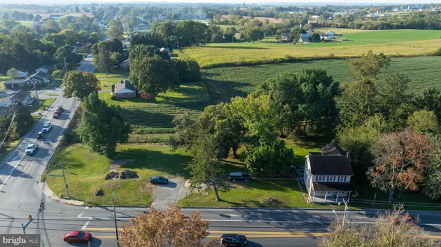 an aerial view of a house with a yard