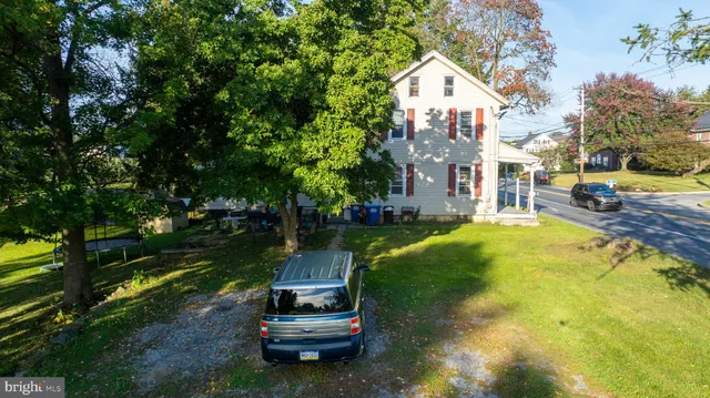 a view of a field with a house in the background