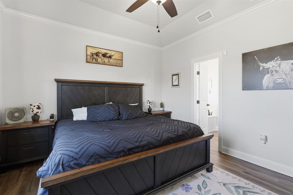 3302 Shelby Road Abilene, TX 79606 - Photo 14 of 29 a bedroom with a bed and wooden floor