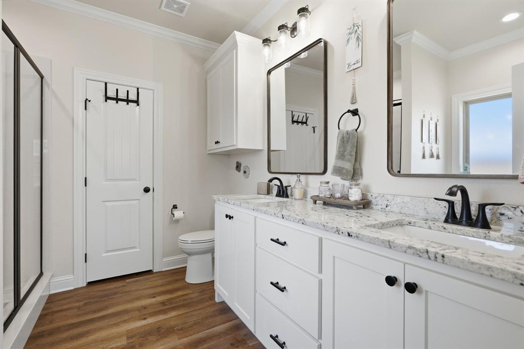 3302 Shelby Road Abilene, TX 79606 - Photo 16 of 29 a bathroom with a granite countertop sink and a mirror