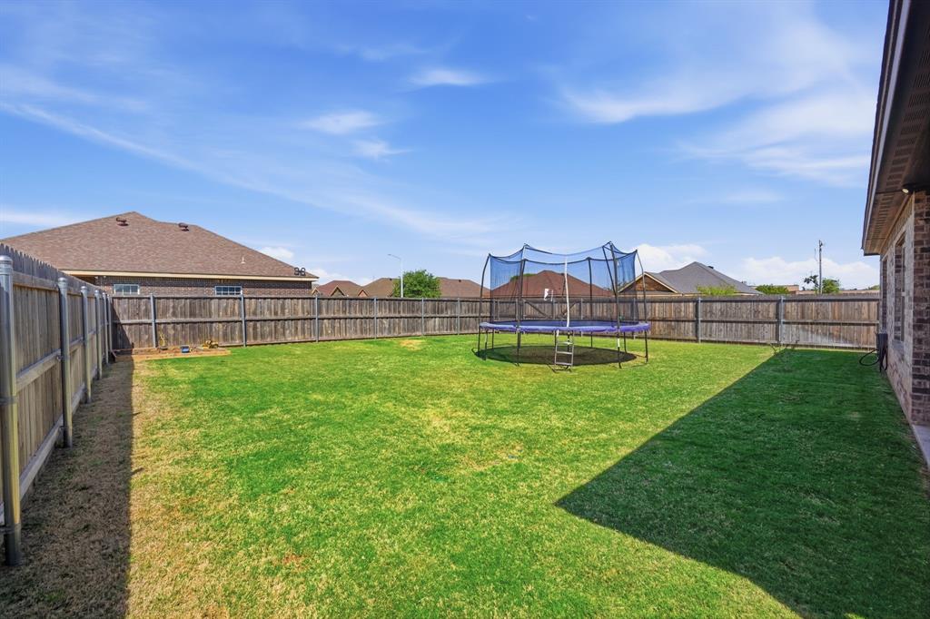 3302 Shelby Road Abilene, TX 79606 - Photo 25 of 29 a view of a house with a big yard and a large tree