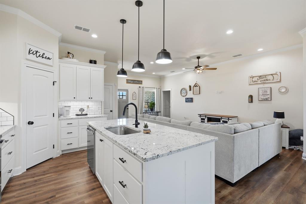 3302 Shelby Road Abilene, TX 79606 - Photo 9 of 29 a kitchen with stainless steel appliances granite countertop a sink a island and windows