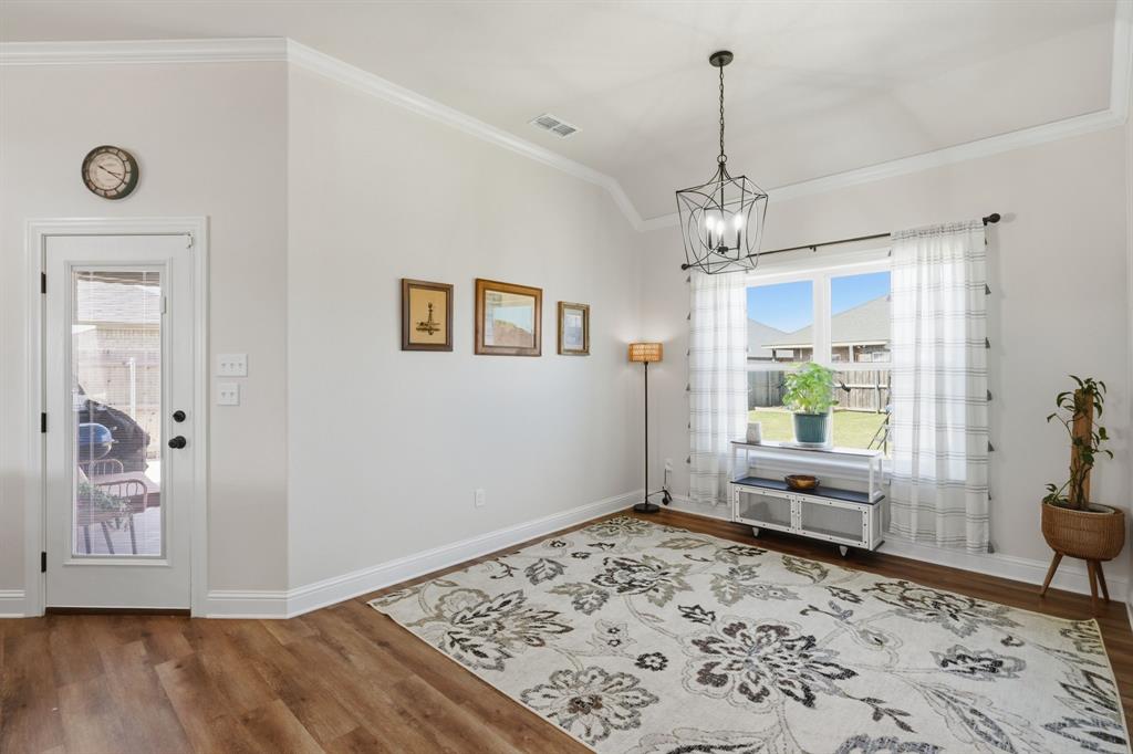 3302 Shelby Road Abilene, TX 79606 - Photo 10 of 29 a view of a livingroom with wooden floor and a chandelier