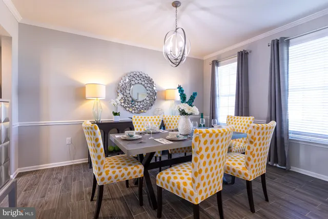 a dining room with furniture a chandelier and wooden floor