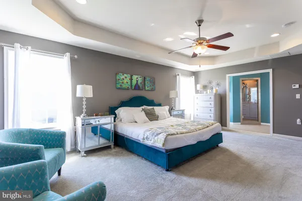 a bedroom with bed and a chandelier