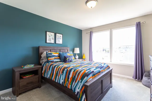 a bedroom with bed and a window