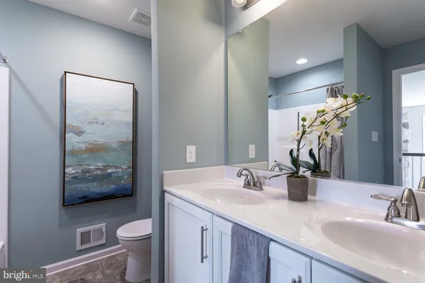 a bathroom with bathtub and glass door