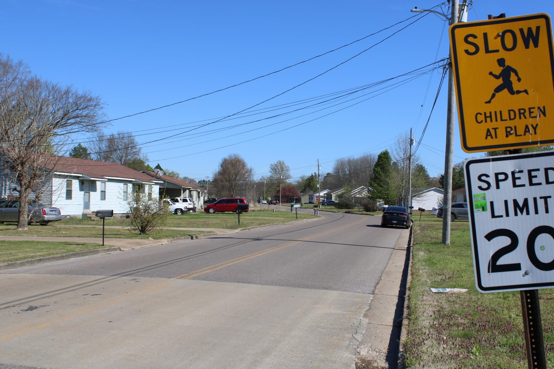 328 Robin Drive Ripley, TN 38063 - Photo 6 of 7 a city street with a building and trees in the background