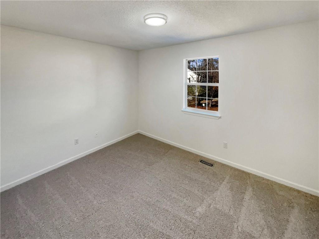 180 Honeysuckle Drive Southeast Calhoun, GA 30701 - Photo 12 of 21 an empty room with a window