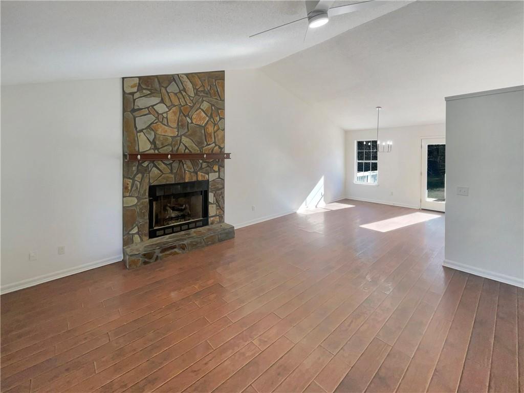 180 Honeysuckle Drive Southeast Calhoun, GA 30701 - Photo 4 of 21 a view of empty room with wooden floor and fireplace