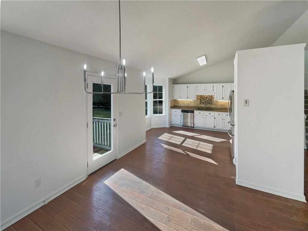 180 Honeysuckle Drive Southeast Calhoun, GA 30701 - Photo 9 of 21 a kitchen with stainless steel appliances granite countertop a refrigerator a stove and a sink with granite countertops