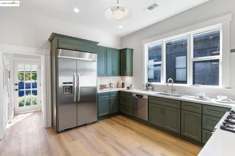 a kitchen with a sink stove and cabinets