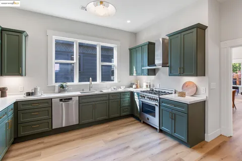 a kitchen with granite countertop a stove and a sink