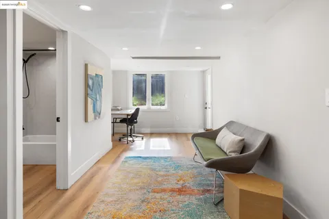 a kitchen with a table chairs and wooden floor