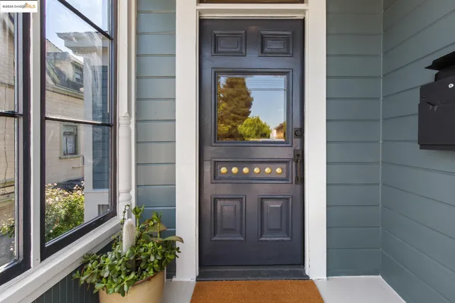a view of a hallway with wooden floor and furniture