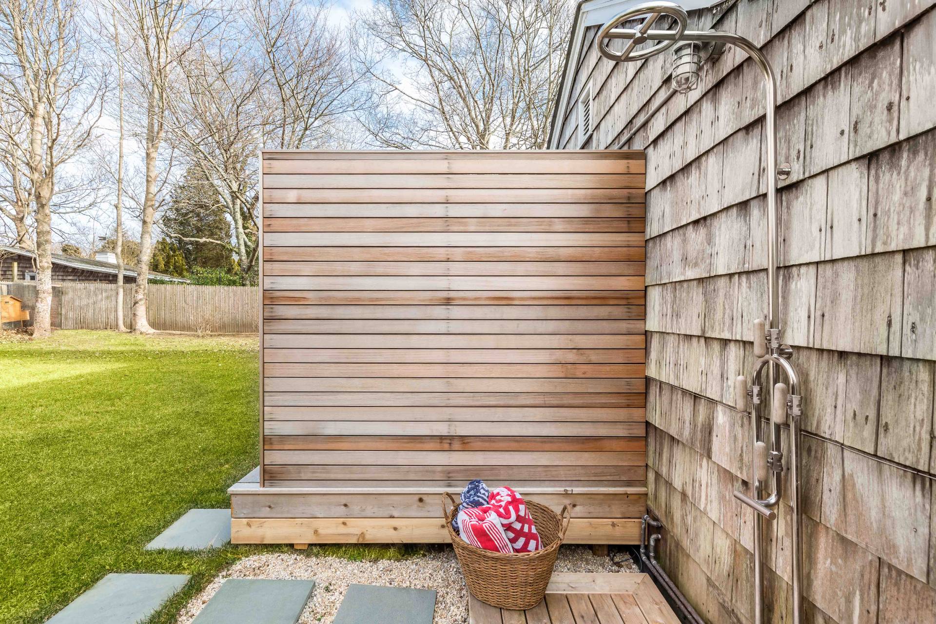 8 Collins Avenue East Hampton, NY 11937 - Photo 20 of 33 a view of a back yard of the house with a wooden bench
