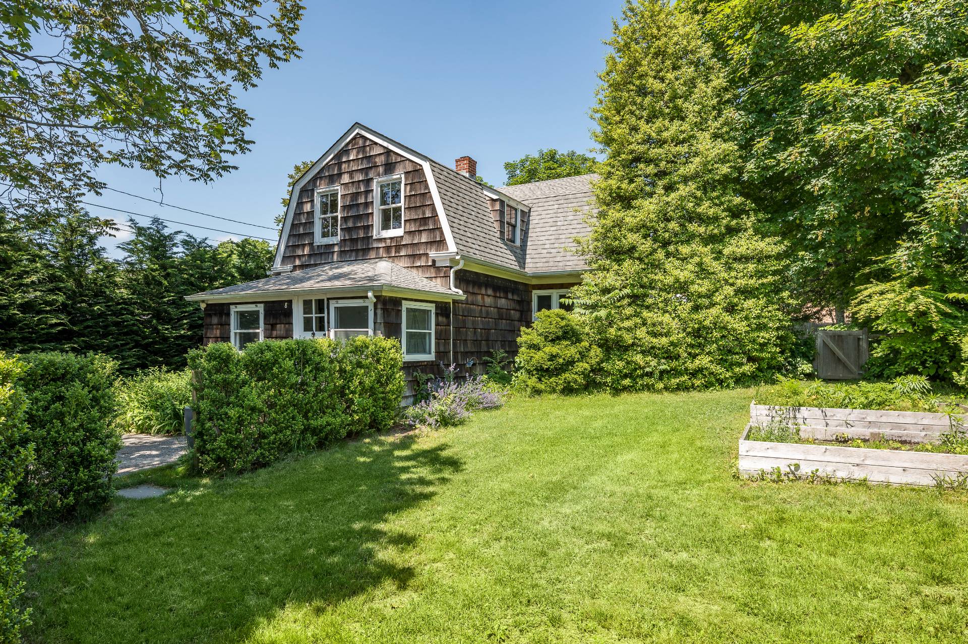 8 Collins Avenue East Hampton, NY 11937 - Photo 22 of 33 a front view of a house with a yard