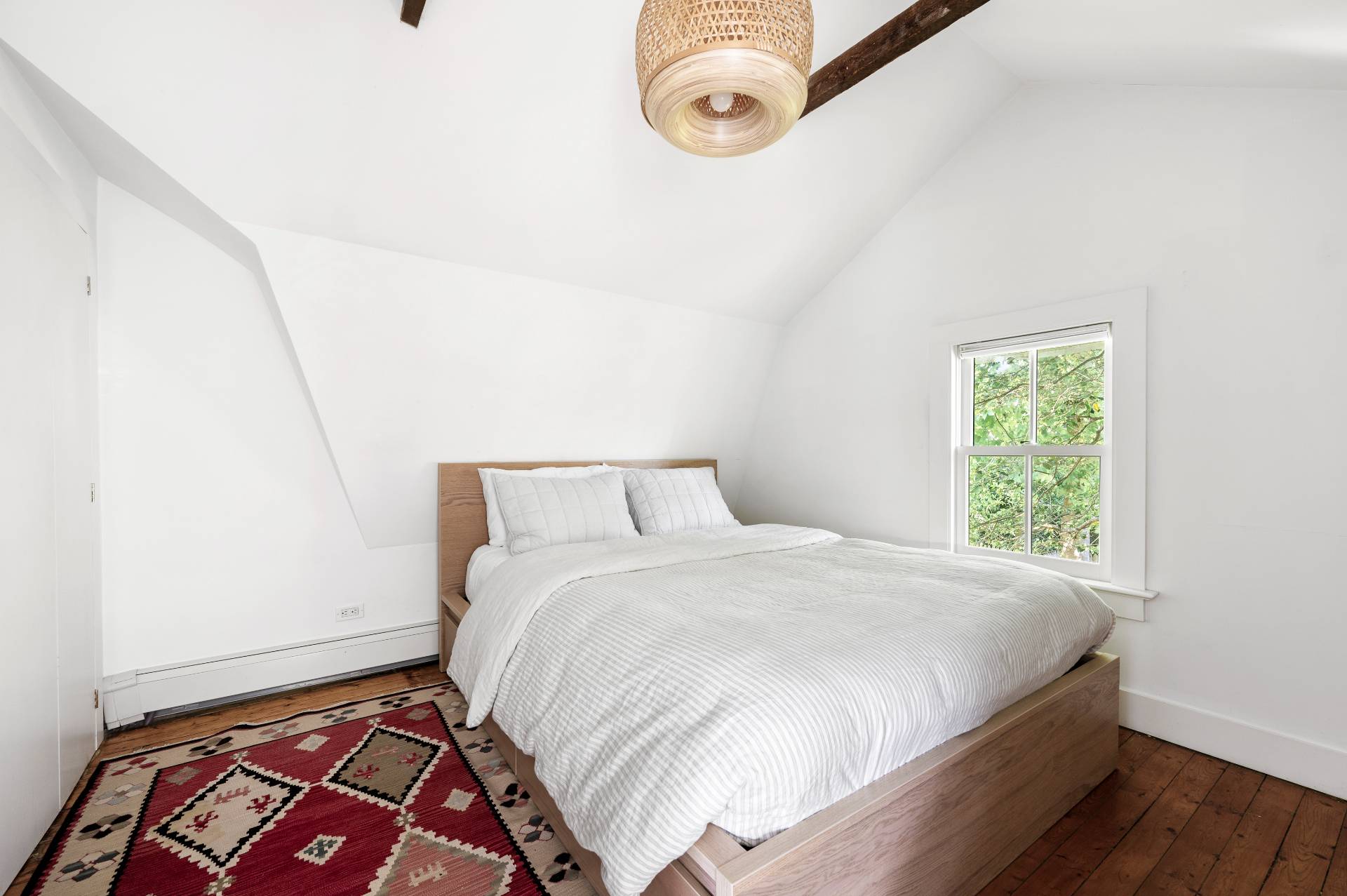 8 Collins Avenue East Hampton, NY 11937 - Photo 9 of 33 a bedroom with a bed and a window