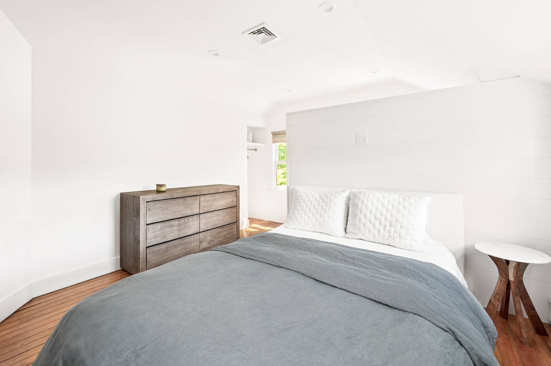8 Collins Avenue East Hampton, NY 11937 - Photo 10 of 33 a bedroom with a bed and a cabinets