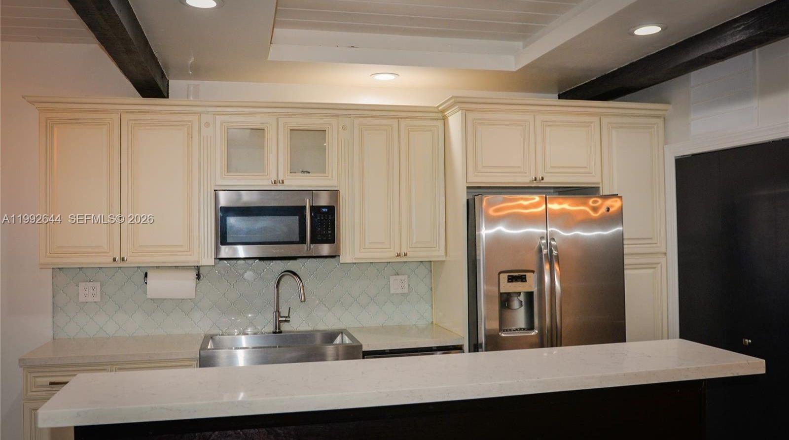 7849 Southwest 103rd Place Miami, FL 33173 - Photo 11 of 64 a kitchen with stainless steel appliances granite countertop a refrigerator a stove top oven a sink and dishwasher