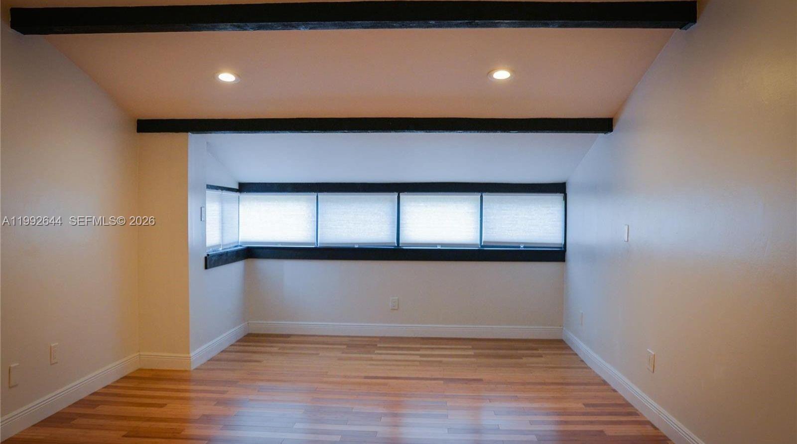 7849 Southwest 103rd Place Miami, FL 33173 - Photo 17 of 64 a view of empty room with wooden floor and fan