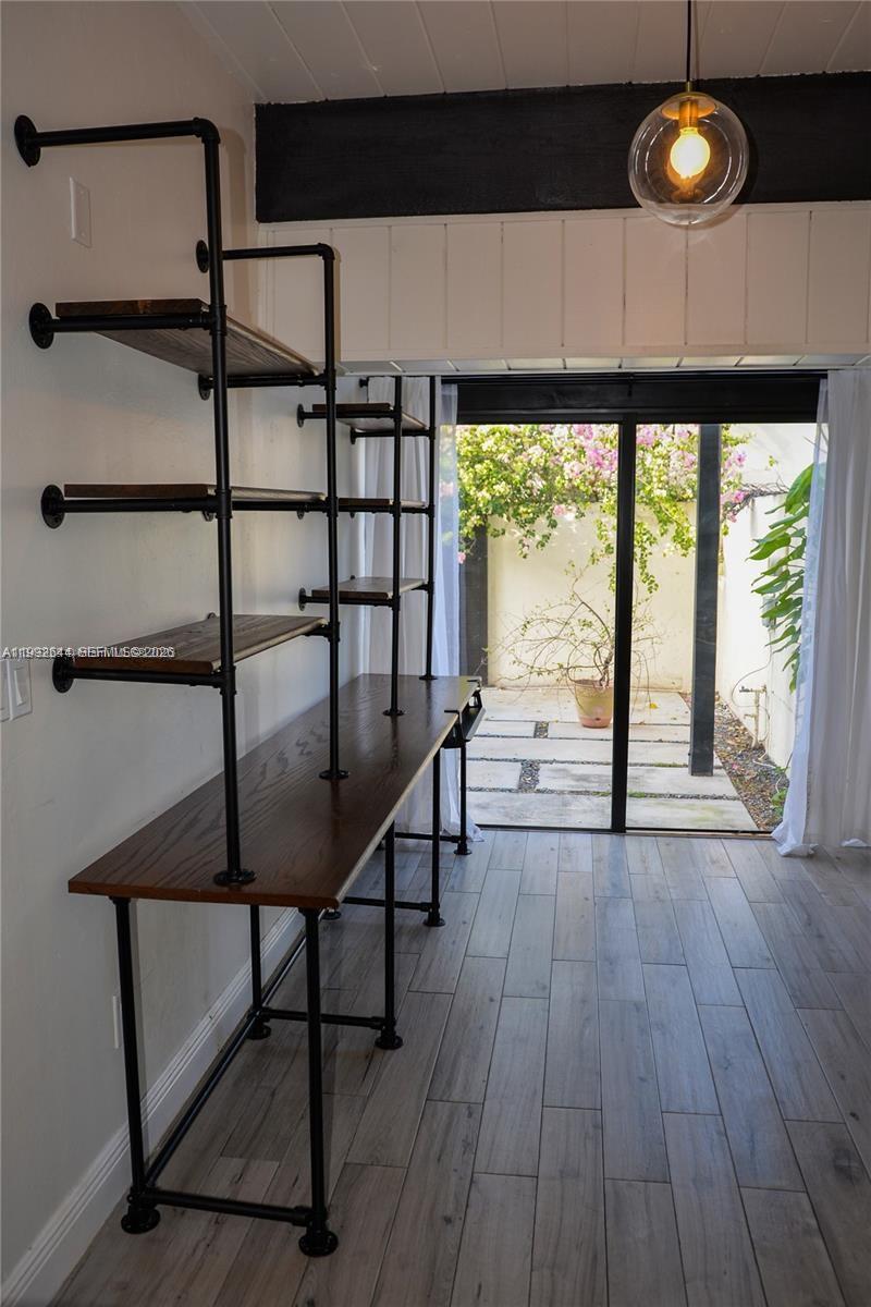 7849 Southwest 103rd Place Miami, FL 33173 - Photo 18 of 64 a view of a room with wooden floor and iron gate