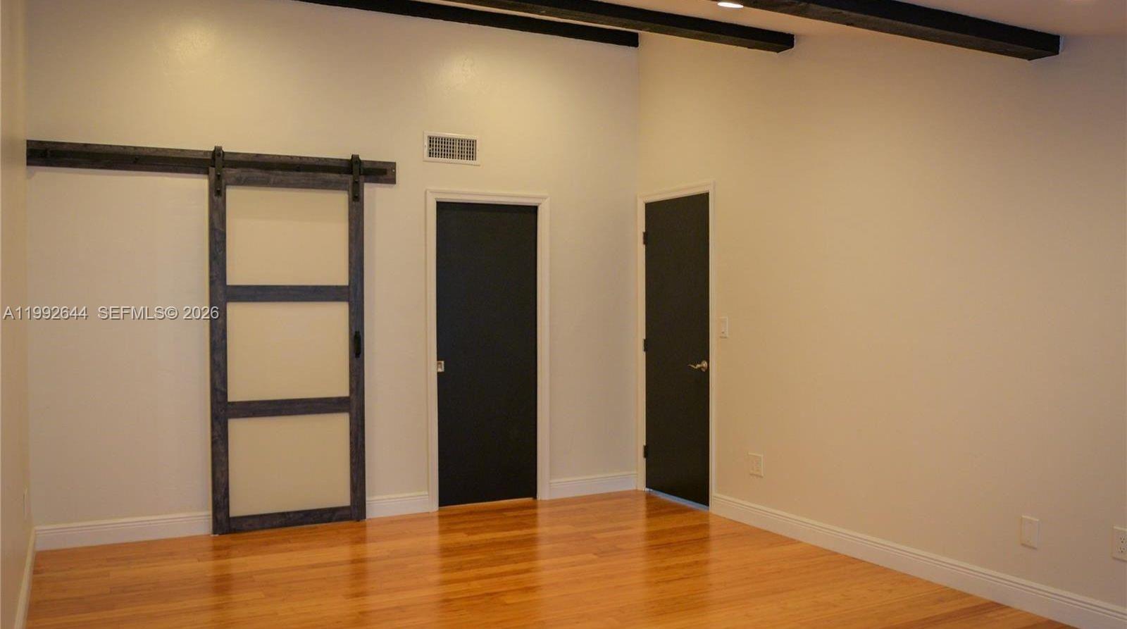 7849 Southwest 103rd Place Miami, FL 33173 - Photo 20 of 64 wooden floor in an empty room