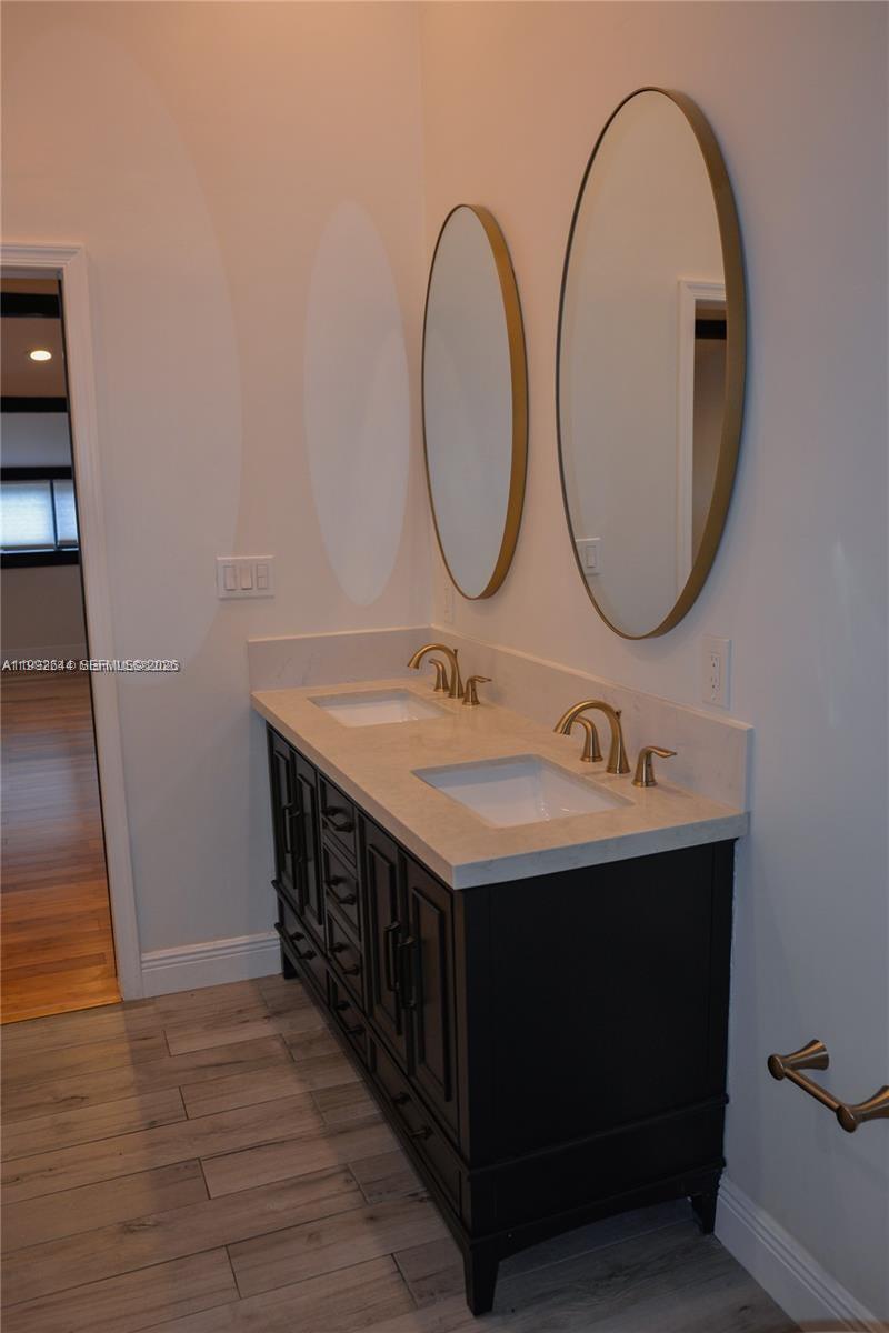 7849 Southwest 103rd Place Miami, FL 33173 - Photo 23 of 64 a bathroom with a sink and a mirror
