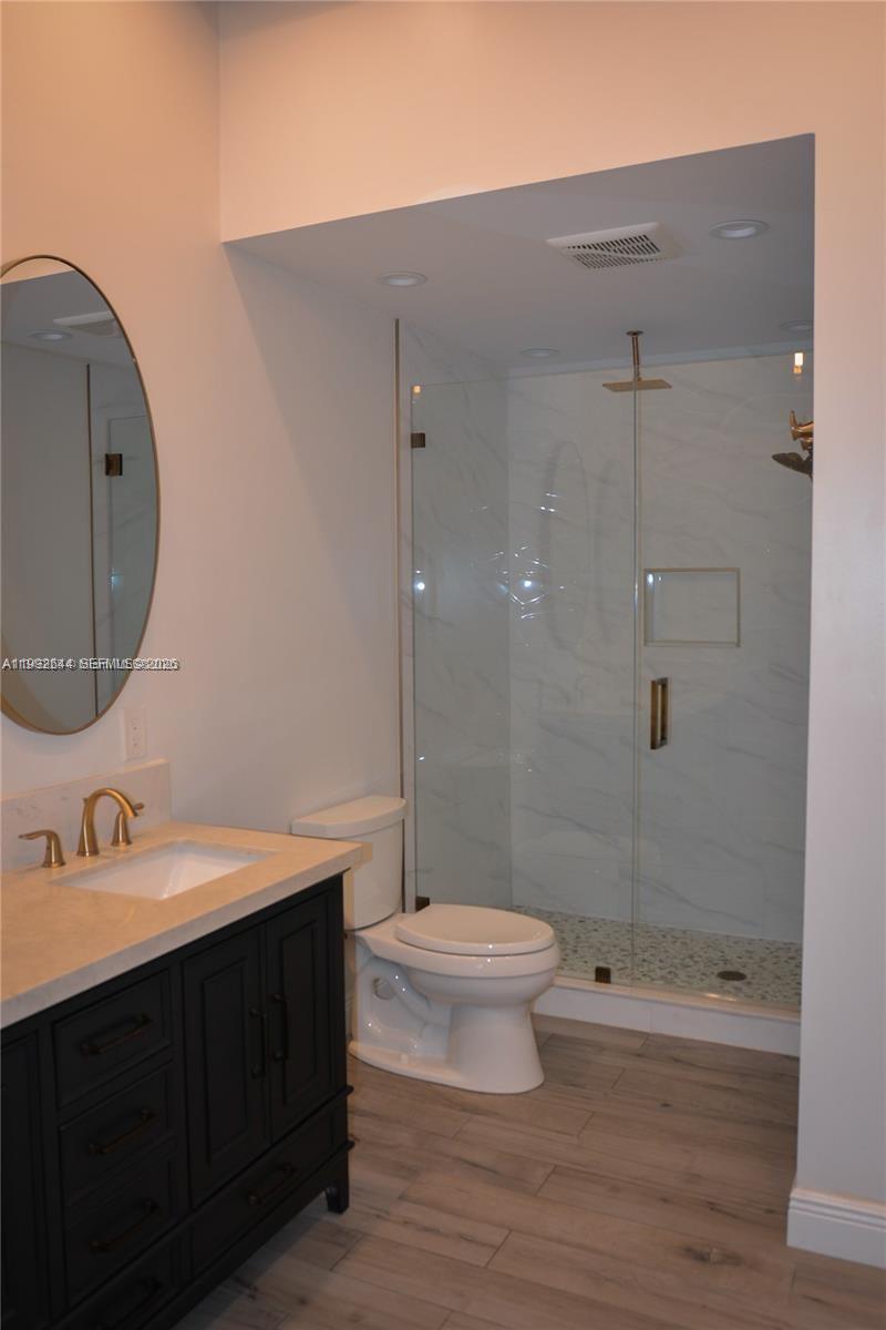 7849 Southwest 103rd Place Miami, FL 33173 - Photo 26 of 64 a bathroom with a sink a toilet and shower