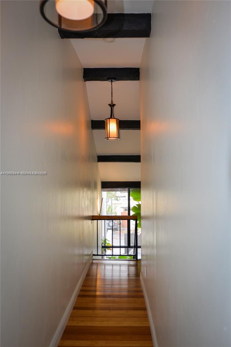 7849 Southwest 103rd Place Miami, FL 33173 - Photo 30 of 64 a hallway with wooden floor table and chairs