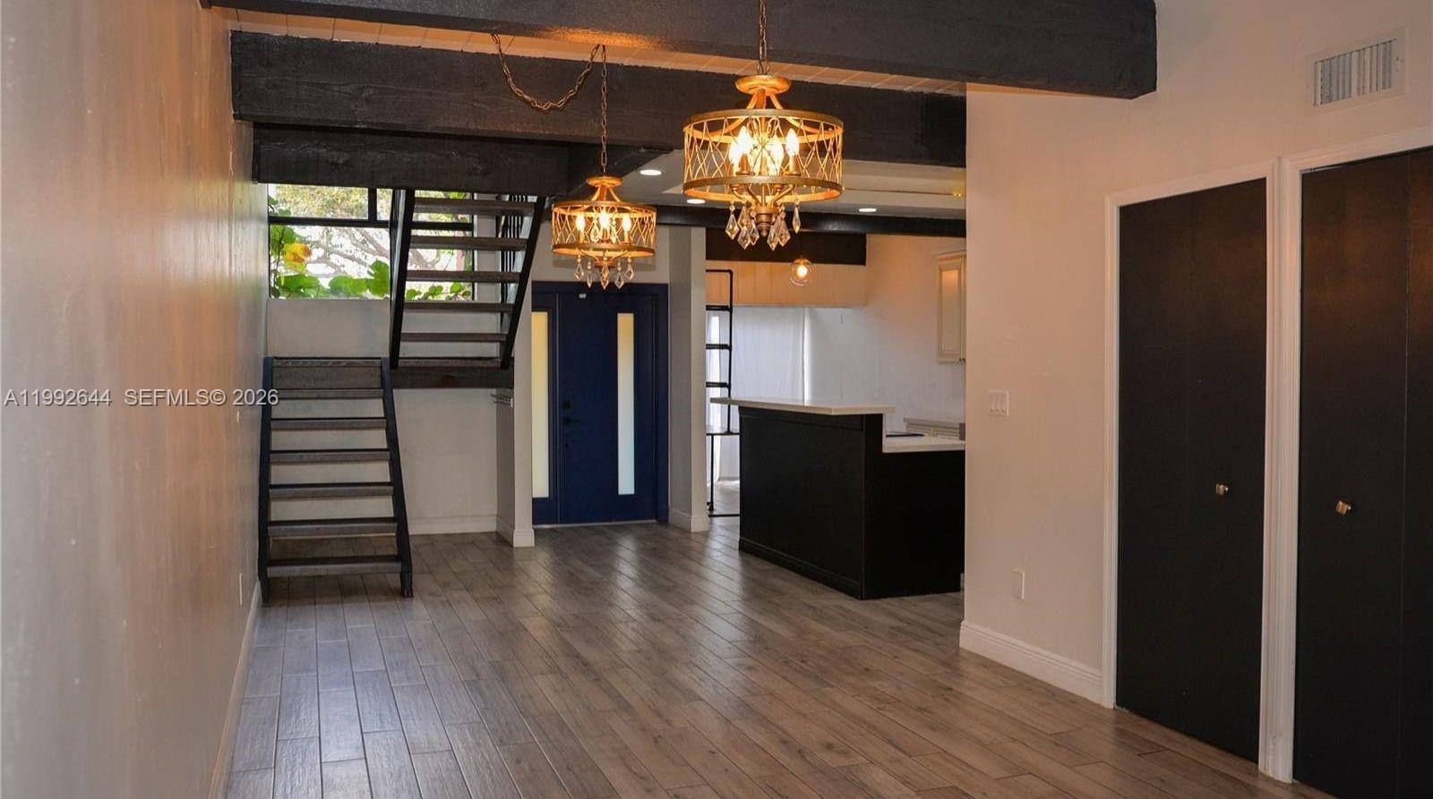 7849 Southwest 103rd Place Miami, FL 33173 - Photo 3 of 64 a view of a hallway with wooden floor and staircase