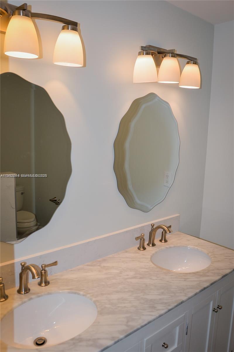 7849 Southwest 103rd Place Miami, FL 33173 - Photo 32 of 64 a bathroom with a sink and a mirror